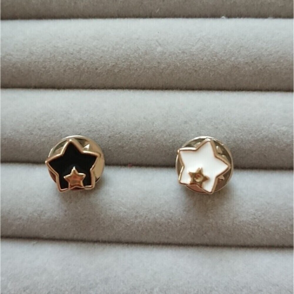 Black and white Star in star brooch/pins